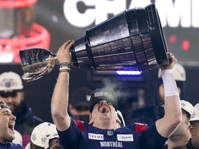 Montreal Alouettes quarterback Cody Fajardo (7) hoists the Grey Cup as the Alouettes celebrate defeating the Winnipeg Blue Bombers in the 110th CFL Grey Cup in Hamilton, Ont., on Sunday, November 19, 2023.