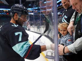 Jordan Eberle #7 of the Seattle Kraken gives a puck to his daughter Collins before the game against the Buffalo Sabres at Climate Pledge Arena on October 25, 2022 in Seattle, Washington.
