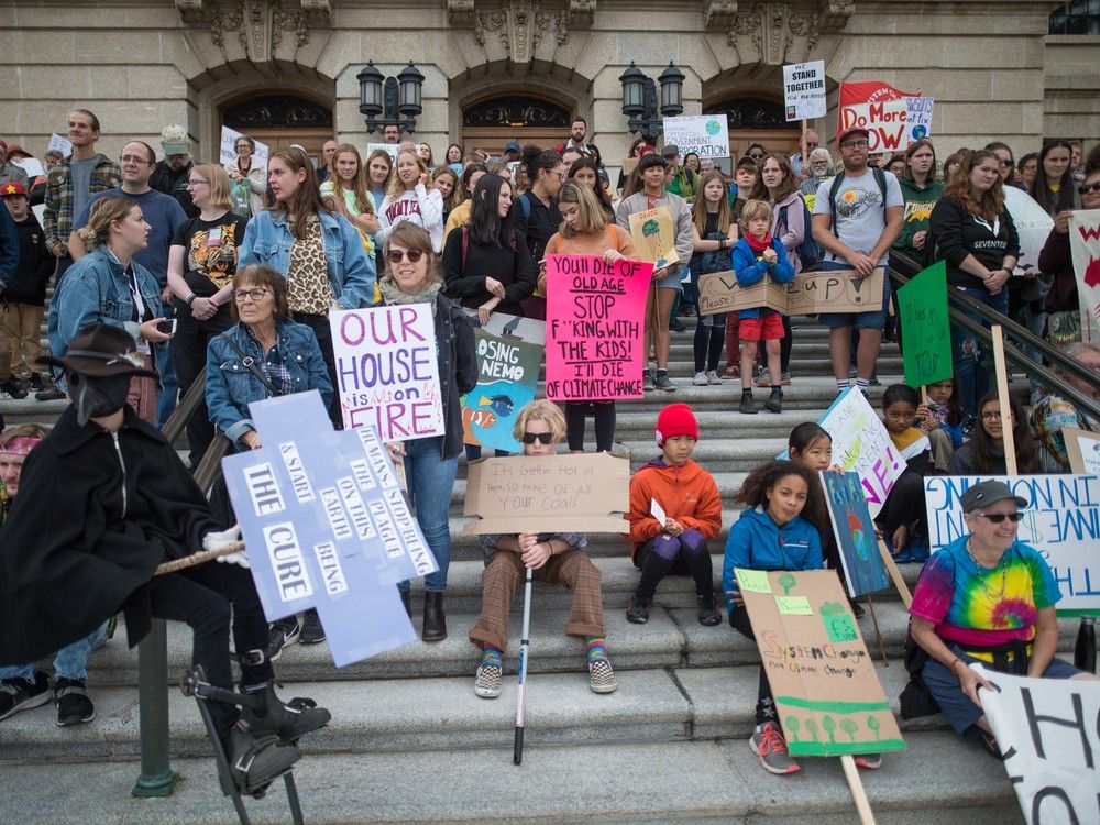 Climate change activists stand on the steps of the Saskatchewan Legislative Building during a rally In Regina, Sask. in September of 2019.