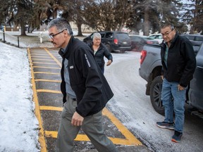 Former RCMP officer Bernie Herman, left, enters the Court of King's Bench on the second day of his trial in Prince Albert, Sask., on Tuesday, Dec. 5, 2023. The first-degree murder trial is set to hear information about an autopsy on Wednesday.