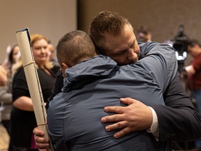Coroner’s counsel Timothy Hawryluk hugs James Smith Cree Nation Chief Wally Burns after the inquest into the apprehension and death of Myles Sanderson