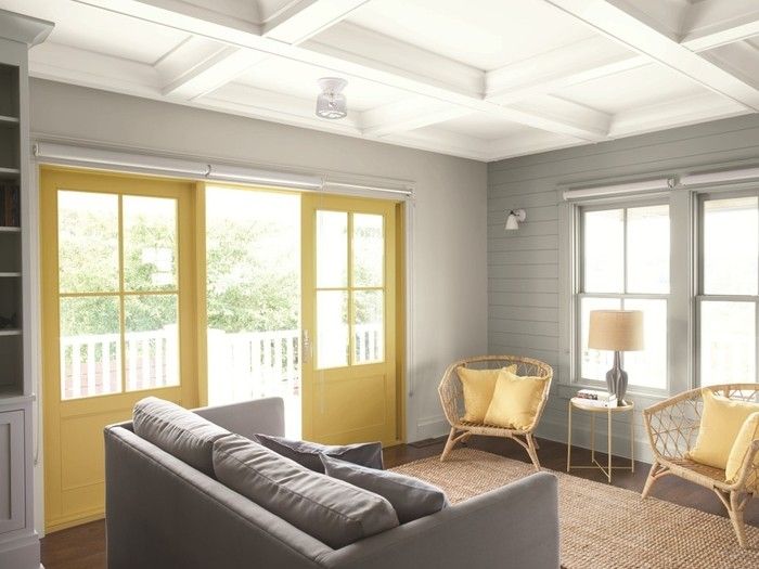 The left-hand wall of this sitting room is painted with Benjamin Moore's Grey Owl (OC-52); the right wall is done with Metropolitan (AF-690); the ceiling is painted in White Heron (OC-57); and the doors are done in Marblehead Gold (HC-11).