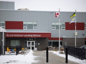 The Saskatchewan flag flies beside the Canadian flag in front of Ecole Harbour School on Thursday, October 26, 2023 in Regina.