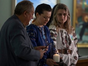 From left to right MLA for Canora-Pelly Terry Dennis, Olha Kolos, and president of the Ukrainian Canadian Congress of Saskatchewan Elena Krueger during a ceremonial candle lighting and moment of silence to mark the second anniversary of Russia's invasion of Ukraine inside the Saskatchewan Legislate Building on Friday, Feb. 23, 2024 in Regina.