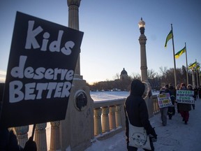 Saskatchewan Teachers' Federation members and supporters march across the Albert Memorial Bridge during a provincial teachers strike on Tuesday, January 16, 2024 in Regina.