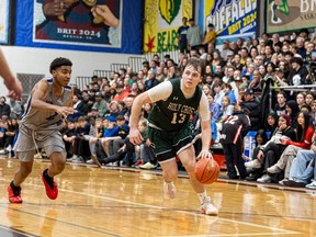 Walter Murray Marauders' Faisal Mahadh and Holy Cross Crusaders' Jack Gray battle in the BRIT 54 championship final. The two teams are set to meet against in the 2023-24 Saskatoon high school basketball league city final.