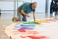 Artist and residential school survivor Jerry Whitehead paints the Saskatoon Residential School Survivors (SRSSC) tipi.