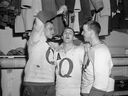 An image of Saskatchewan Junior Hockey League's Junior Quakers players, from left, Bill Orban, winger Gord Grandberg and goalie Colin Twidale celebrating their 6-4 victory over the Flin Flon Bombers in the seventh and deciding game in the first round of playoffs, from March 21, 1964.