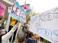 Heated exchanges between protesters and counter-protesters over school pronoun policy take place along Saskatoon's riverbank on Wednesday, September 20, 2023.