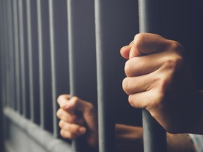 Hands on jail bars