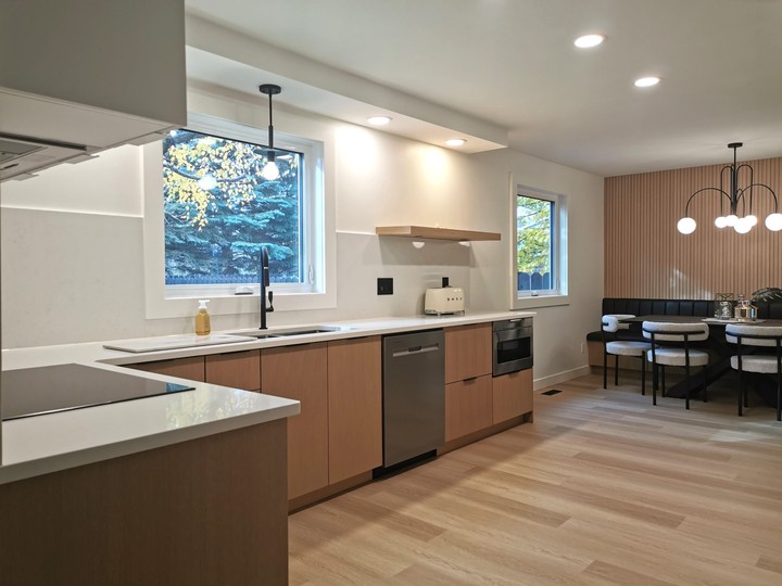  The Centennial Kitchen & Bath team transformed a dated ’80s-style kitchen (below) into a bright, modern and open space (above). The kitchen won a 2024 Housing Excellence Award for Best Kitchen Renovation (under $50,000). To achieve the homeowner’s vision for her kitchen, the 1980’s style dark oak cabinets were removed and an interior wall separating the dining room was torn down.