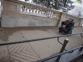 Lynnett Boris demonstrates the use of an accessibility ramp at the Saskatchewan Legislative Building on Dec. 4, 2023. Boris is part of a group called Barrier Free, which celebrated after the Accessible Saskatchewan Act came into force during International Day of Persons with Disabilities.