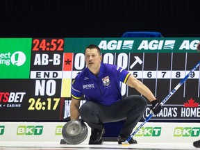 Team Alberta lead Ben Hebert looks down ice before delivering a rock during pool A action at the 2024 Montana's Brier inside the Brandt Centre, March 4.