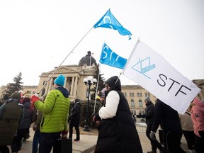 Teachers and supporters walk around the Saskatchewan Legislative Building grounds during their two-day job action on Wednesday, March 20, 2024 in Regina.