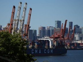Gantry cranes are shown as a container ship is docked at port in Vancouver, on Wednesday, July 19, 2023.