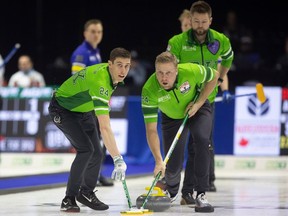 Team Saskatchewan lead Daniel Marsh sweeps beside third Colton Flasch during pool B action at the 2024 Montana's Brier inside the Brandt Centre on Tuesday, March 5, 2024 in Regina.