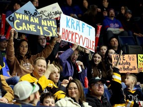 Fans inside the Brandt Centre during a Regina Pats game hold up signs in support of Wolseley vying for the title of Kraft Hockeyville.