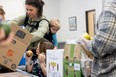 Terri Lynn and her children pack boxes of food during the last run of the CHEP Good Food Box program.