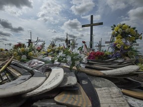 Hockey sticks, messages and other items at a memorial for the Humboldt Broncos bus crash at the intersection of Highways 35 and 335 on Wednesday, August 1, 2018. The crash killed 16 people and injured 13 others after a bus carrying the Humboldt Broncos collided with a transport truck at the rural intersection on April 6, 2018. (Saskatoon StarPhoenix/Liam Richards)