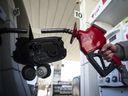 A woman fills up her car with gas in Toronto, on April 1, 2019.