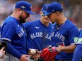 Toronto Blue Jays manager John Schneider (left) continues making strange managerial decisions,