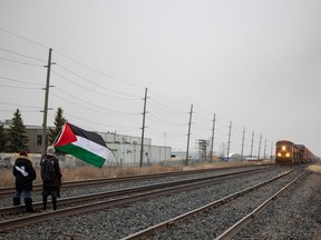 Pro-Palestinian activists call for a two-way arms embargo against Israel by blocking a Canadian Pacific rail line near Park Street and 7th Avenue on Wednesday, April 17, 2024 in Regina.