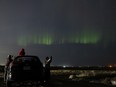 People pulled over on the side of 8th Street East in Saskatoon to get a glimpse of the Aurora Borealis -- the northern lights -- during a massive solar storm. Photo taken in Saskatoon, Sask. on Sunday, May 12, 2024.