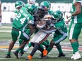 Members of the Saskatchewan Roughriders make a tackle on BC Lions running back Taquan Mizzell (23) during the first half of pre season CFL action at Mosaic Stadium on Saturday, May 27, 2023 in Regina.
