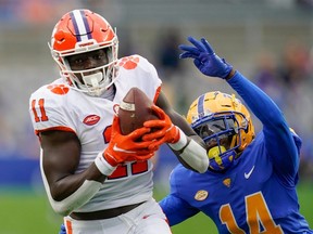 Clemson wide receiver Ajou Ajou (11) makes a catch past Pittsburgh defensive back Marquis Williams (14) during the first half of an NCAA college football game, Saturday, Oct. 23, 2021, in Pittsburgh.