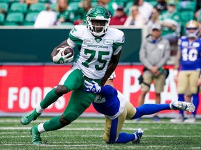 Winnipeg Blue Bombers defensive back Juan Lua (32) attempts to tackle Saskatchewan Roughriders receiver Ajou Ajou (75) as he runs the football during second the half of preseason CFL football action in Regina, on Monday, May 20, 2024.