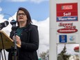 Saskatchewan NDP Leader Carla Beck speaks at a podium in front of a gas station next to Northgate Mall to call for tax relief on gas prices on Wednesday, May 22, 2024 in Regina.