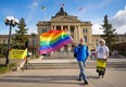 A person holds a pride flag during a pro-LGBTQ2+ rally outside of the Saskatchewan Legislative Building in Regina on Friday, May 17, 2024.