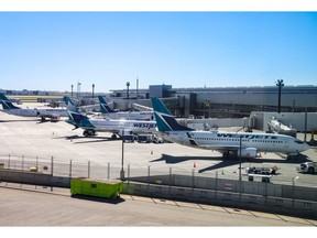 WestJet Boeing 737 aircraft are parked at Calgary International Airport on Wednesday, June 26. The airline's mechanics walked off the job Friday night in a surprise strike call.