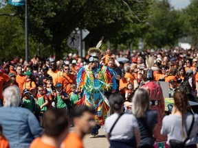 Adrian Waskewitch grass dances as hundreds walk along the river near Victoria Park in Saskatoon on June 21, 2024 for the 2024 Rock You Roots walk for reconciliation on National Indigenous Peoples Day.