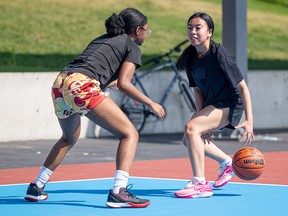 (From left) Shalom Chinheya and Angel Celestino play 3x3 basketball at the Pawatetan basketball courts in preparation for the YXE Urban Games local 3x3 tournament. Photo taken in Saskatoon, Sask. on Tuesday, August 13, 2024.