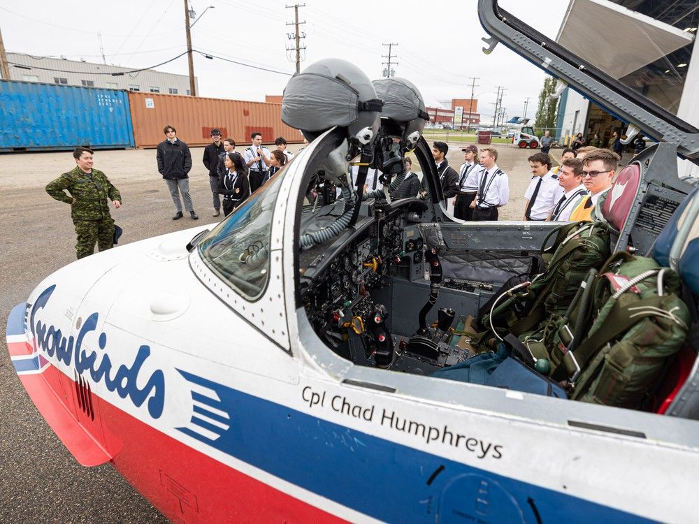 Master-Cpl Kate Ballard shows SIIT students the Snowbirds' CT-114 Tutor aircraft.