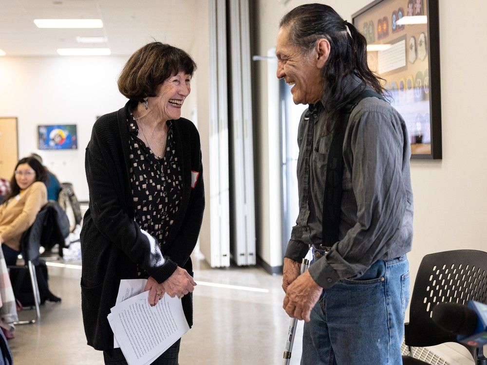 Dr. Isbel Fendley, left, talks with David Fleminate during the discussion of the Housing Rights Society at Station 20 West.