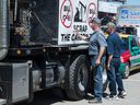 Visitors to the Saskatchewan Oil and Gas Exhibition in Webern, Sask, signed a carbon anti -carbon tax on a truck semi -June 2019.