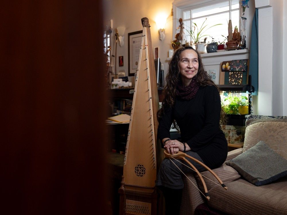 music Multi-instrumentalist Anna Bekolay sits for a photo with her giant double-bowed psaltery.
