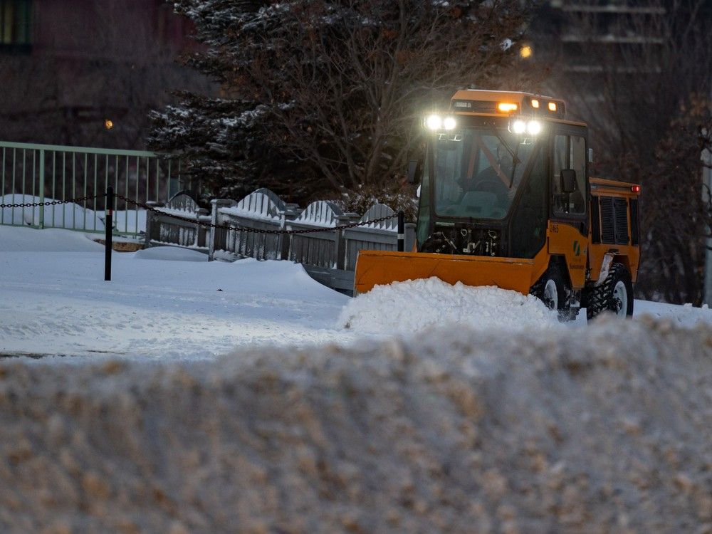 A City of Saskatoon worker plows snow off the walking path from the Broadway Bridge to Broadway Avenue after a heavy snowfall. Photo taken in Saskatoon, Sask. on Thursday, Dec 18, 2025.