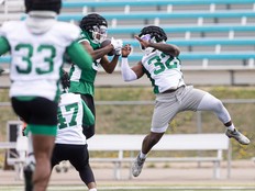 Saskatchewan Roughriders KeeSean Johnson (3) and A.J. Allen (32) during training camp at Griffiths Stadium.