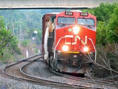A CN freight train rolls under the Bayridge Drive overpass in Kingston, Ont,. on June 19, 2024.