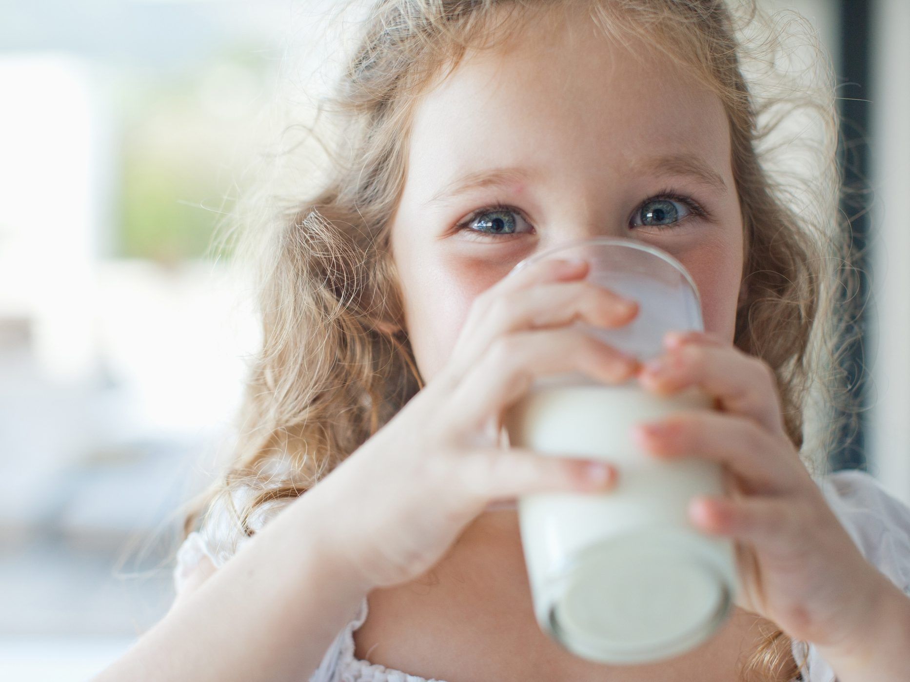 Girl drinking glass of milk.