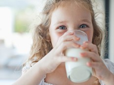 Girl drinking glass of milk.