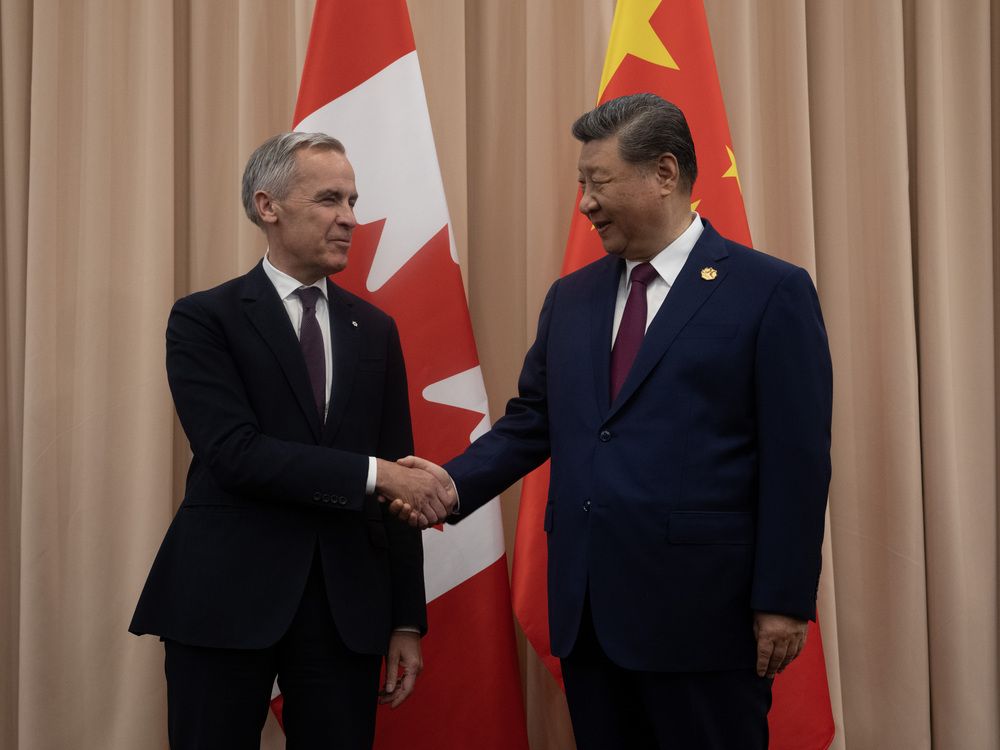 Prime Minister Mark Carney, left, with Chinese President Xi Jinping at the start of a meeting in Gyeongju, Oct. 31, 2025.