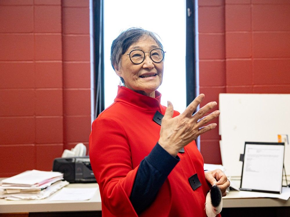 A woman stands in her office for a portrait.