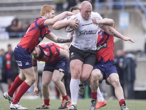 Toronto Wolfpack's Steve Crossley (centre) carries the ball through the Oxford defence during their 62-12 win in their inaugural home opener in Kingstone Press League 1 Rugby action in Toronto on Saturday, May 6, 2017.