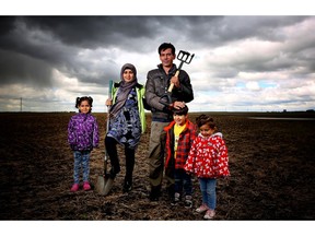 Recent Syrian refugees Mohamed El Daher, 39 and his wife Nahiama, 32, with their children Aicha, 6, Raibeh, 5 and Aber, 3, at borrowed plot of land they are farming near city.