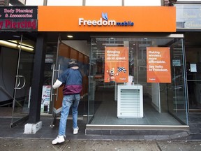 A man enters a Freedom Mobile store in Toronto on Thursday, November 24, 2016.