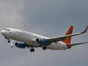 A Sunwing Boeing 737-800 passenger plane prepares to land at Pearson International Airport in Toronto on Wednesday, August 2, 2017. (THE CANADIAN PRESS/Christopher Katsarov)